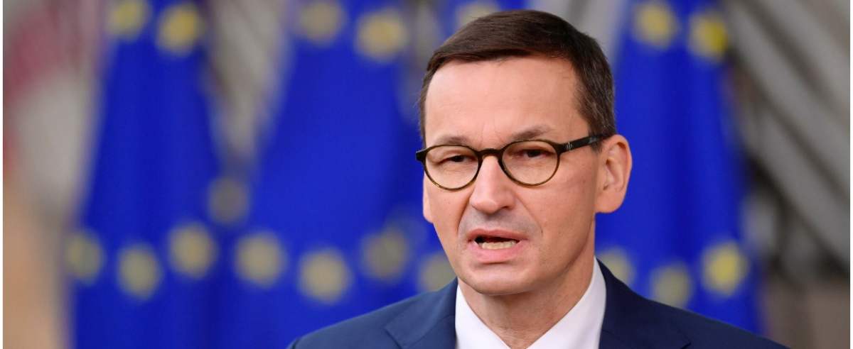 Poland's Prime Minister Mateusz Morawiecki speaks to the press as he arrives at the EU headquarters' Europa building in Brussels on December 10, 2020, prior to a European Union summit. (Photo by JOHN THYS / POOL / AFP)